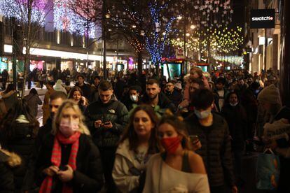 People walk down Oxford Street in London on December 27. 