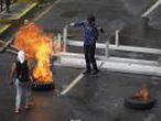 Opposition supporters set up barricades during clash with security forces in Caracas