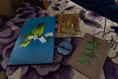 Some of the drawings of the young refugee Rahif Almeari on the wooden sheets prepared by his father.  In addition to Palestinian symbols, the teenager also paints nature and landscapes.  