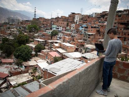 CARACAS, VENEZUELA - APRIL 27: A teenager student Jose Lara uses his computer at the roof of his house whilte trying to connect to the internet and receive his homework for the week during the second month of quarantine in the Country on April 27, 2020 in Caracas, Venezuela. Due to the government-ordered coronavirus lockdown, students in Venezuela will have to attend classes remotely until the end of the school year on July 10th. In most cases, teachers connect with their students daily or weekly through e-mail or social media. Online education is a challenge in a country with a very unstable and slow internet service, frequent power outages and low-income households where parents lack of time to spend teaching their kids. (Photo by Leonardo Fernandez Viloria/Getty Images)
