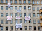 FILE PHOTO: Banners hang from an apartment block on Karl Marx Allee in Berlin, Germany, November 20, 2018, to protest against plans to sell flats on a boulevard of imposing Stalinist architecture that was one of the flagship building projects of the former German Democratic Republic after World War Two. Banners read "capitalist avenue" and "tenants action against speculation". Picture taken November 20, 2018.     REUTERS/Joachim Herrmann/File Photo