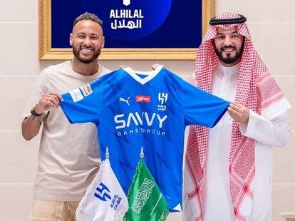 Neymar holds their shirt as he poses with President Fahd