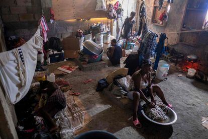 A woman washes clothes inside a shelter for families displaced by gang violence at Saint Yves Church in Port-au-Prince.