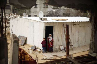 Una familia palestina en una casa improvisada con material prefabricado que se levantó tras los bombardeos israelíes sobre la franja del pasado verano.