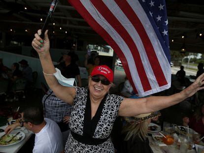 A supporter of U.S. President Donald Trump waves an American flag during a boat parade to rally for his reelection, in Fort Lauderdale, Florida, U.S., October 3, 2020. REUTERS/Marco Bello