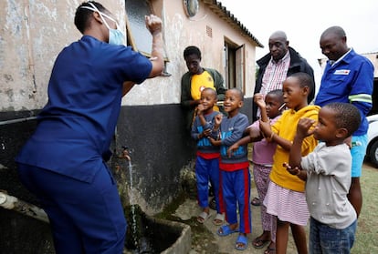 Una trabajadora sanitaria enseña a lavarse las manos a los niños del suburbio de Umlazi, cerca de Durban (Sudáfrica), el 4 de abril de 2020, para detener el contagio por coronavirus.