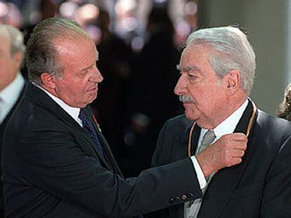 El rey Juan Carlos impone a Álvaro Mutis la medalla que le acredita como premio Cervantes.