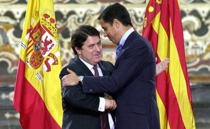 El expresidente del Gobierno valenciano José Luis Olivas (izquierda) abraza a su antecesor, Eduardo Zaplana, tras entegarle la Alta Distinción de la Generalitat, en Valencia en 2002.