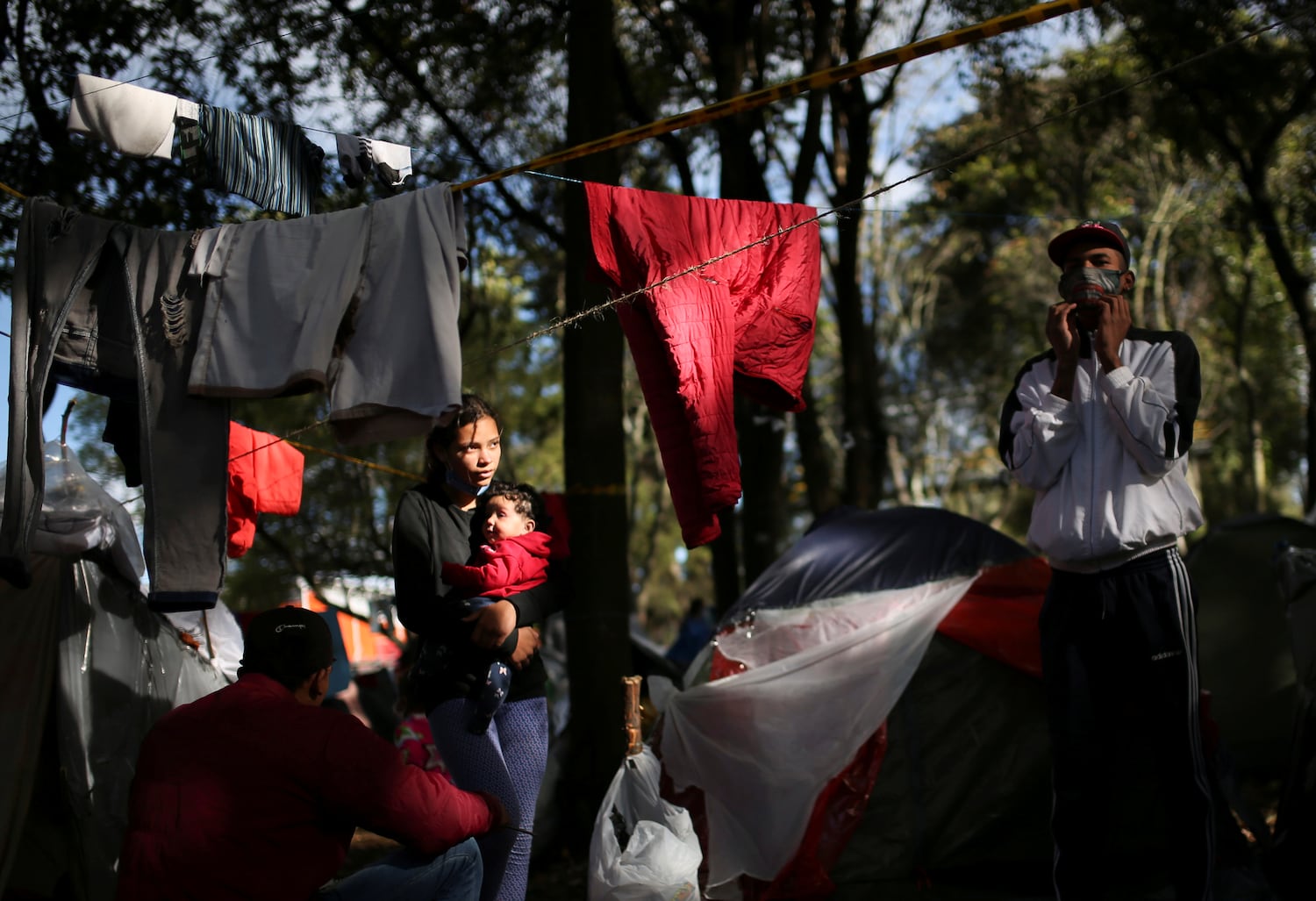 Una migrante venezolana carga a su bebé en un campamento improvisado en las afueras de Bogotá.