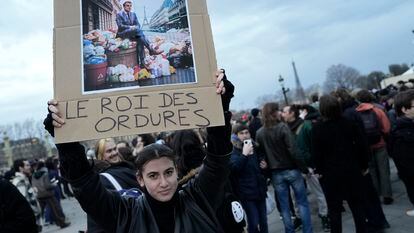 Una joven sostenía un cartel con la fotografía de Macron y la frase "El rey de las basura", en una protesta en París, el pasado viernes.