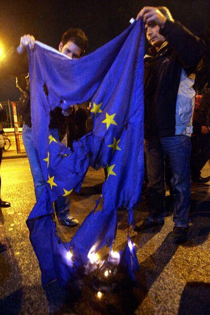 Varios manifestantes queman una bandera de la Unión Europea ayer en Atenas.