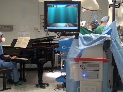 A still image taken from a video shows medical staff led by Dr. Roberto Trignani performing surgery to remove a double tumour in the spinal cord of a 10-year-old child as molecular biologist Emiliano Toso plays music on the piano with a frequency believed to have a therapeutic affect on the patient at the Salesi Pediatric Hospital in Ancona, Italy, November 16, 2020. Picture taken November 16, 2020. Fondazione Salesi/Handout via REUTERS ATTENTION EDITORS THIS IMAGE HAS BEEN SUPPLIED BY A THIRD PARTY. NO ARCHIVE. NO RESALE.