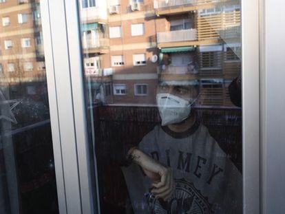 Una persona con mascarilla en su domicilio, a 29 de diciembre de 2021, en Madrid.