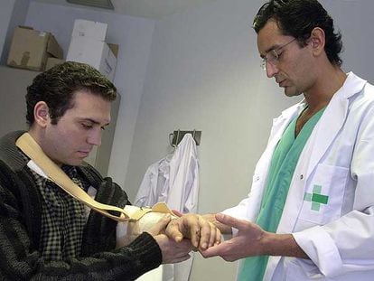 El doctor Pedro Cavadas, en 2004 con un paciente al que reimplantó un brazo amputado.