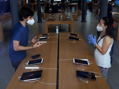 Dos consumidores miran tabletas en el interior de la tienda Apple de la Puerta del Sol, en Madrid.