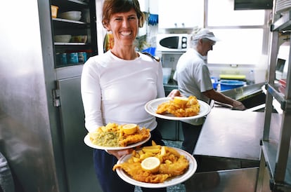 Teresilla Poveda Gunn serving fish and chips at Ray's Chippy.