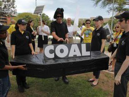 Activistas escenifican el entierro del carbón en Durban durante la cumbre del clima.