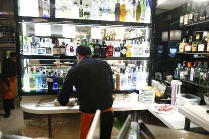 A waiter attends the bar in a bar in Madrid.