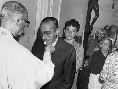 El dictador Jorge Videla recibe la comuni&oacute;n de un sacerdote local.