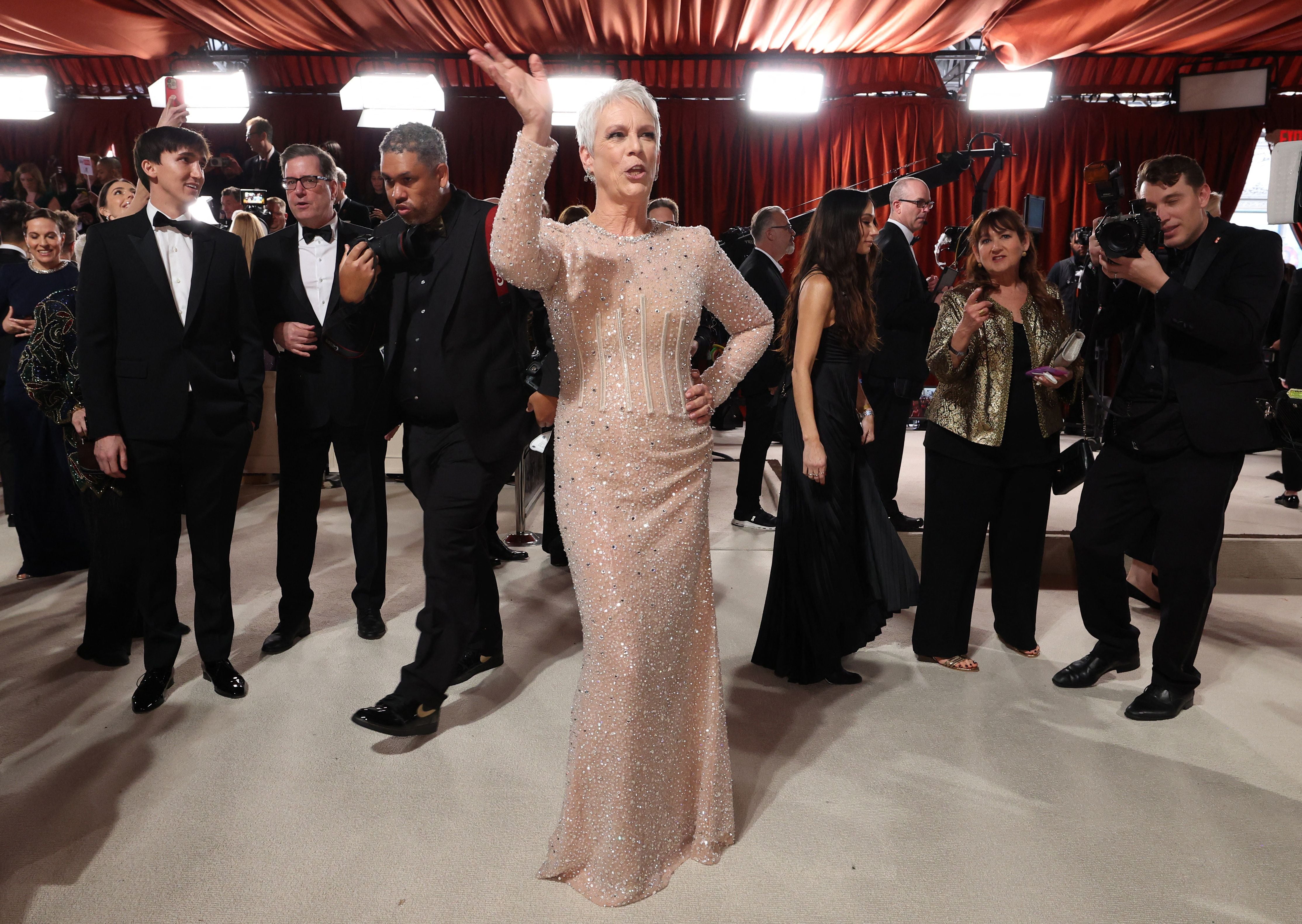 Jamie Lee Curtis poses on the champagne-colored red carpet during the Oscars arrivals at the 95th Academy Awards in Hollywood, Los Angeles, California, U.S., March 12, 2023. REUTERS/Mario Anzuoni