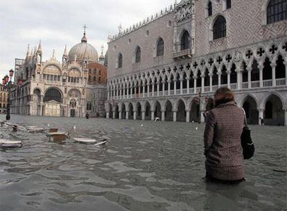 Una mujer atraviesa la plaza de San Marcos durante el <i>acqua alta.</i>