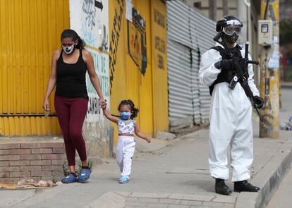Un soldado con un traje para la covid vigila una calle de Ciudad Bolívar, uno de los barrios más afectados por la pandemia en Bogotá.