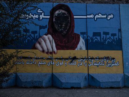 A mural of a woman with her face crossed out after an act of vandalism, in Kabul last September.