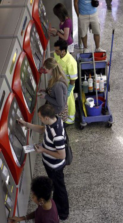 Viajeros en las máquinas expendedoras de billetes en la estación madrileña de Sol.