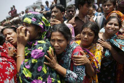Dacca, Bangladesh, 24 de abril de 2013. Un grupo de mujeres llora por sus familiares, atrapados en el derrumbe de un edificio en Dacca, Bangladesh. Al menos 243 personas murieron por el derrumbe de un edificio en las afueras de Dacca. Los equipos de rescate encontraron a 24 supervivientes. El número de heridos superó el millar. El edificio Rana Plaza, de ocho plantas y que acogía varios talleres textiles, un mercado y una sucursal de un banco, se vino abajo a primera hora de la mañana del día 24 en la población de Savar, a 24 kilómetros al noroeste de la capital de Bangladesh.