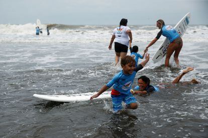 En las playas del departamento salvadoreño de La Libertad, el proyecto Surfitsmo busca que los niños con autismo aprendan a domar las olas como terapia de estimulación. En la imagen, niños e instructores de surf juegan en las playas del municipio de Chilitupán, el 14 de agosto de 2022.