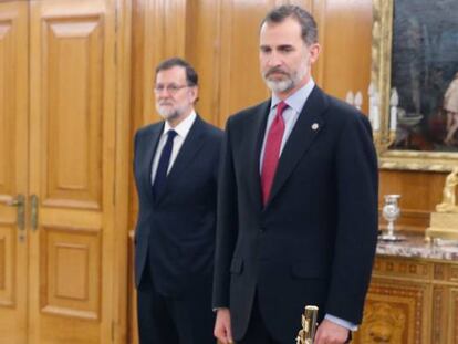 El nuevo ministro de Economía, Román Escolano (izquierda), jura su cargo ante el Rey Felipe VI (derecha) en el Palacio de la Zarzuela de Madrid, en presencia del presidente del Gobierno, Mariano Rajoy.