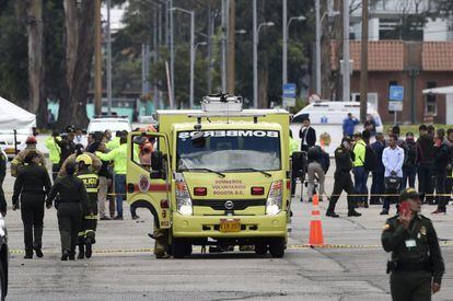 El coche ha rebasado los controles de seguridad y ha estallado en el patio de desfiles. Una de las personas fallecidas es el conductor. Las autoridades investigan si se trata de un atentado suicida, un 'modus operandi' nada común en Colombia. En la imagen, los servicios de emergencia acuden a la Escuela de Policía General Santander tras la explosión.