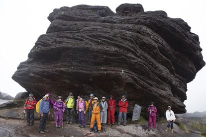 Varios turistas japoneses se refugian de la lluvia junto a una formación rocosa en la cima del monte Roraima, situado en Venezuela y muy cerca de la frontera con Brasil y la Guyana.