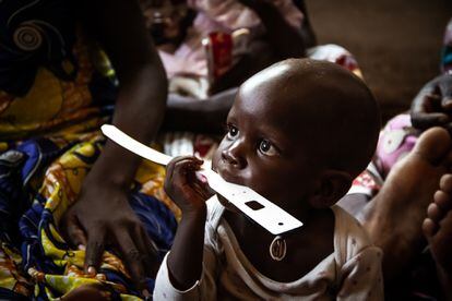 Un niño del centro de salud de Kourgui mordisquea una cinta métrica con la que las madres aprenden a medir el perímetro braquial para saber si sus hijos están desnutridos.