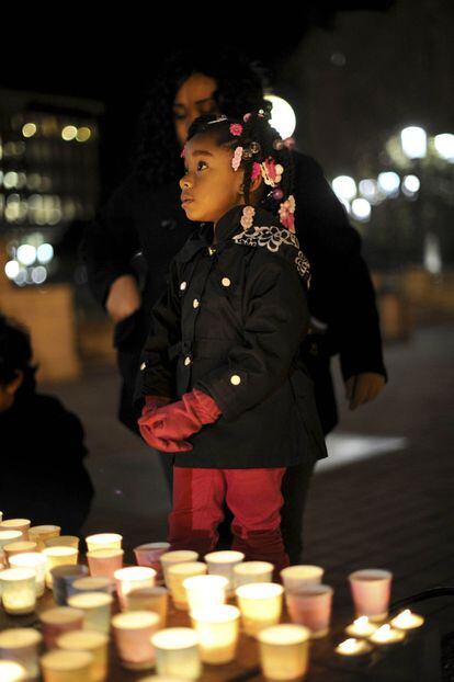 Aminah Crawford, una niña de cuatro años, ante un lugar de oración callejero en Oakland, California.