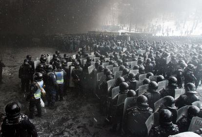 Un nutrido grupo de policías se agrupa para enfrentarse a unos manifestantes protegidos tras barricadas montadas en una calle de Kiev (Ucrania). Su actuación provocó la muerte de dos activistas y así se incrementó más la tensión en las calles de la capital ucrania.