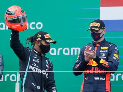 Hamilton, aplaudido por Verstappen, celebra el triunfo en Nurburgring alzando el casco de Michael Schumacher que le regaló el hijo del piloto alemán.