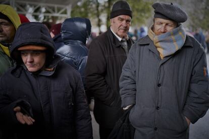 Residents of Bucha line up outside the hospital to receive food