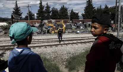 Dos niños observan el desmantelamiento del campamento de Idomeni, en Grecia.