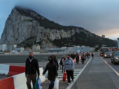 Peatones y vehículos cruzan la pista del aeropuerto de Gibraltar camino de la Verja para pasar a España.