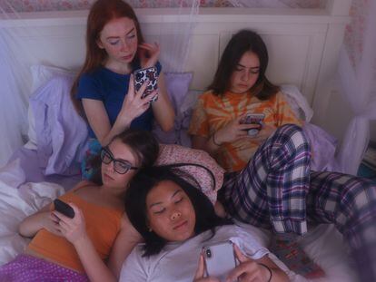 Un grupo de adolescentes utiliza sus teléfonos móviles.