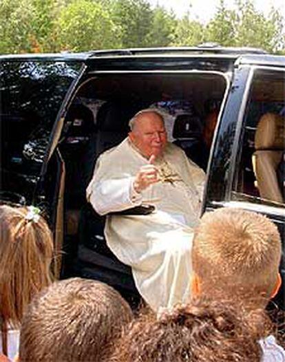 Juan Pablo II saluda a numerosos vecinos a su llegada a Les Combes, a unos 1.700 metros de altitud.