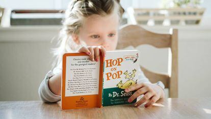 Una niña lee un libro en inglés.