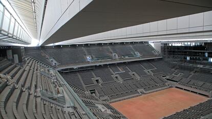 FILE - In this Wednesday, May 27, 2020 file photo, a general view of the Philippe-Chatrier tennis court with its new retractable roof during a media tour at Roland Garros stadium in Paris. Damir Dzumhur's coach called Roland Garros organizers "inhuman” on Tuesday, Sept. 22 for excluding the Bosnian player from the tournament, because the coach failed a coronavirus test. Dzumhur, a former top-30 player now ranked 114, tested negative for the virus himself but was barred from the qualifying draw for the clay major because he and his coach, Petar Popovic, shared a room in Paris. (AP Photo/Michel Euler, file)
