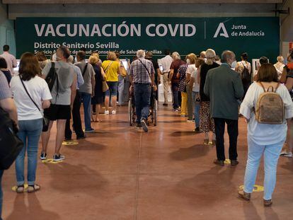 Colas para sacar número en el centro de vacunación instalado en el Estadio Olímpico de Sevilla este jueves.