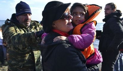 La actriz Susan Sarandon sostiene a un niño refugiado en la isla Lesbos.