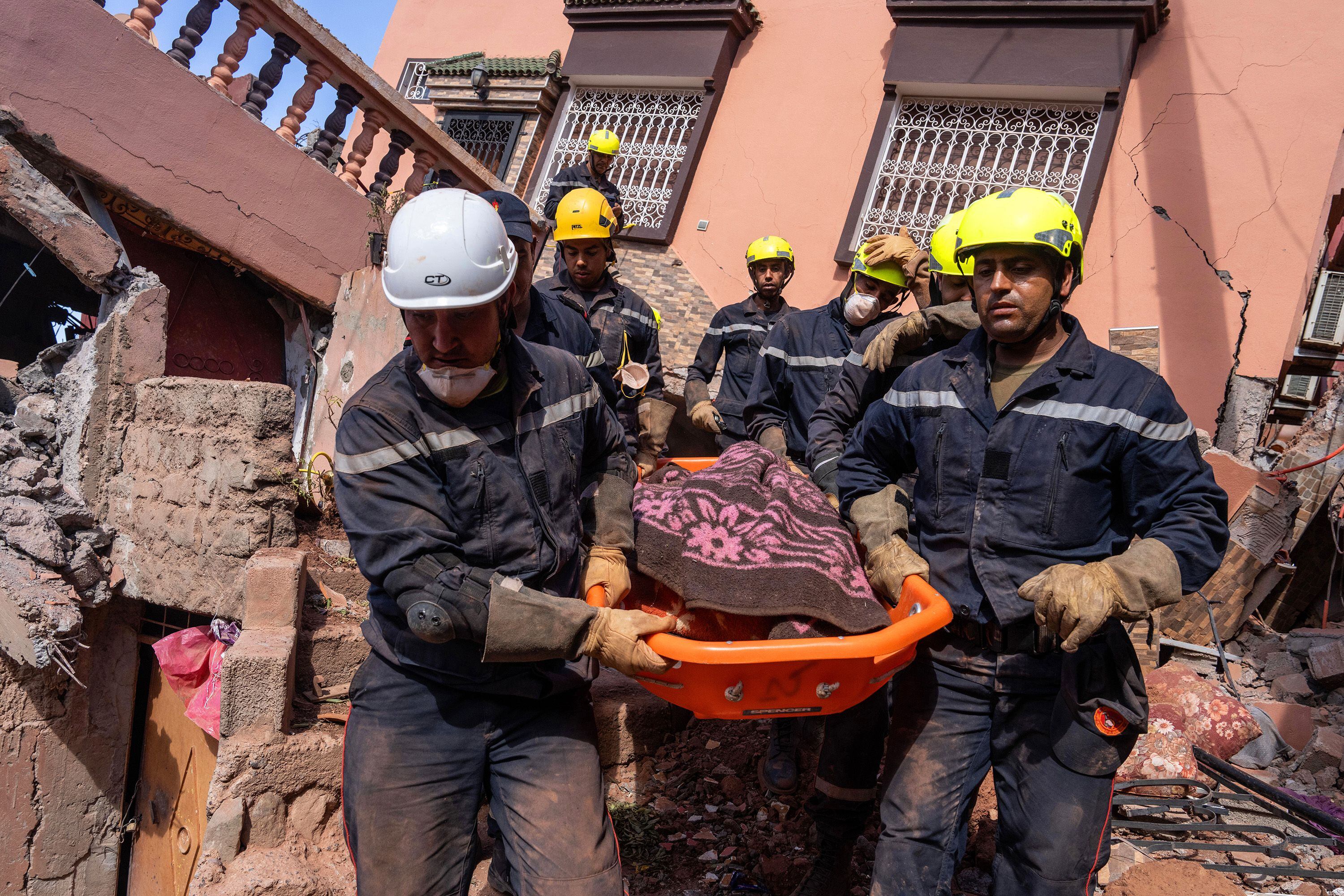 Personal de emergencias traslada el cadáver de una víctima tras el terremoto, en Ouirgane. 