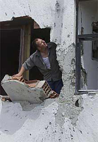 Un albanés de Aracinovo observa el estado de su casa tras un ataque.