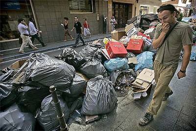 Un hombre se tapaba la nariz, ayer, al pasar junto a la basura acumulada en las calles del centro de Almería.