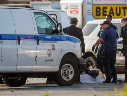 EDS NOTE: GRAPHIC CONTENT - A body is retrieved from a van by the Los Angeles County Coroner in Torrance Calif., Sunday, Jan. 22, 2023. A mass shooting took place at a dance club following a Lunar New Year celebration, setting off a manhunt for the suspect. (AP Photo/Damian Dovarganes)